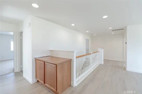 an empty room with windows and a fireplace