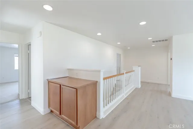 an empty room with windows and a fireplace