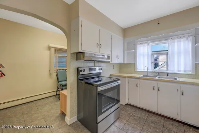 a kitchen with a sink stove and cabinets