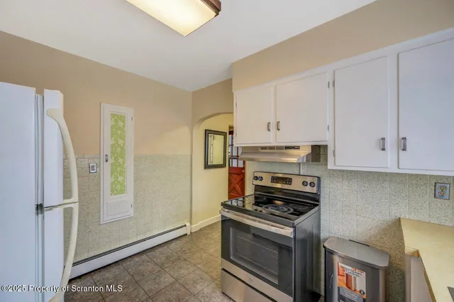 a white refrigerator freezer sitting inside of a kitchen