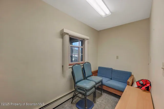 a living room with furniture and a kitchen