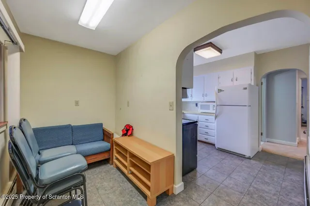 a view of a livingroom with furniture and a bathroom