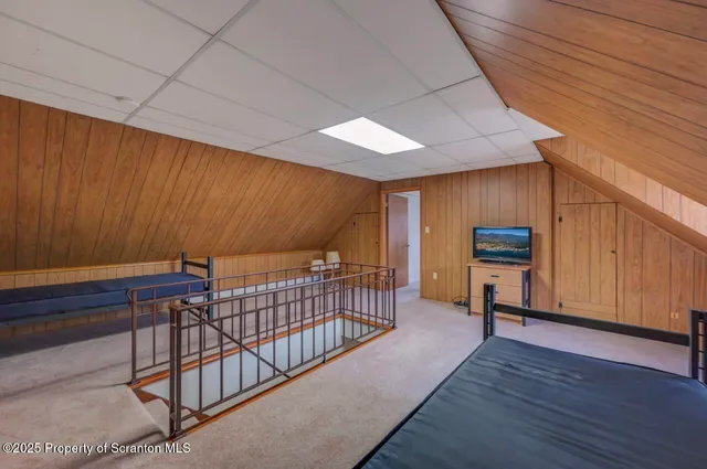 a room with a wooden table and chairs