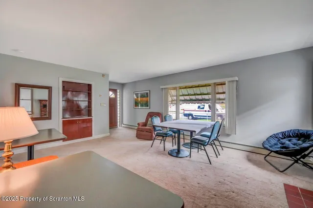 a living room with furniture a lamp a rug and a window