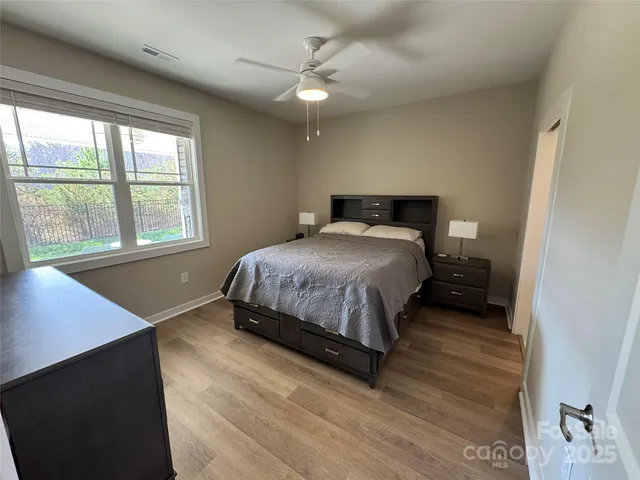 a bedroom with a bed next to a window