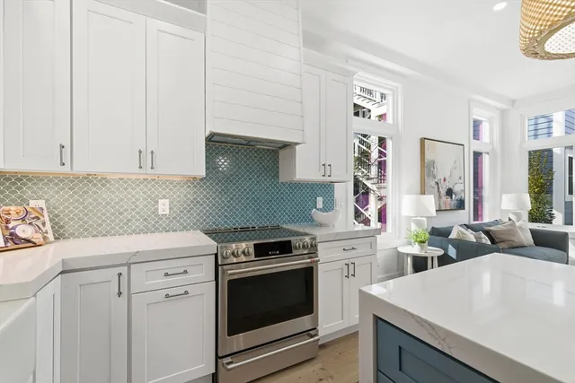 a kitchen with white cabinets and white appliances