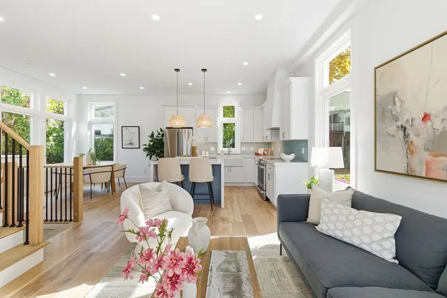 a living room with furniture and kitchen view