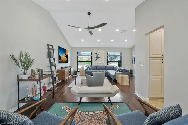 a living room with furniture a rug and a flat screen tv