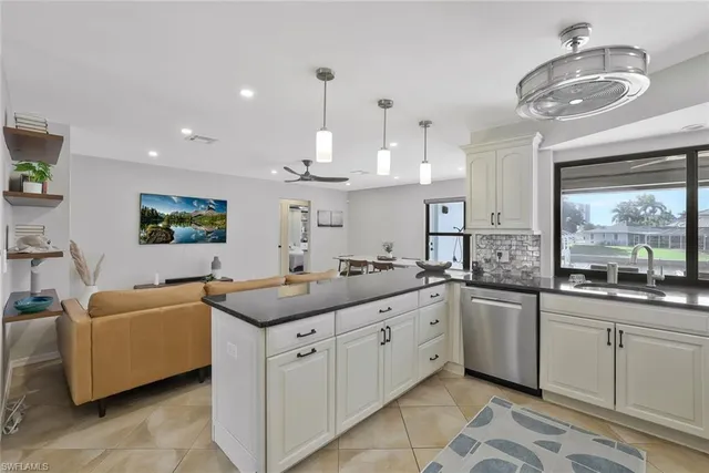 a kitchen with cabinets a sink and appliances