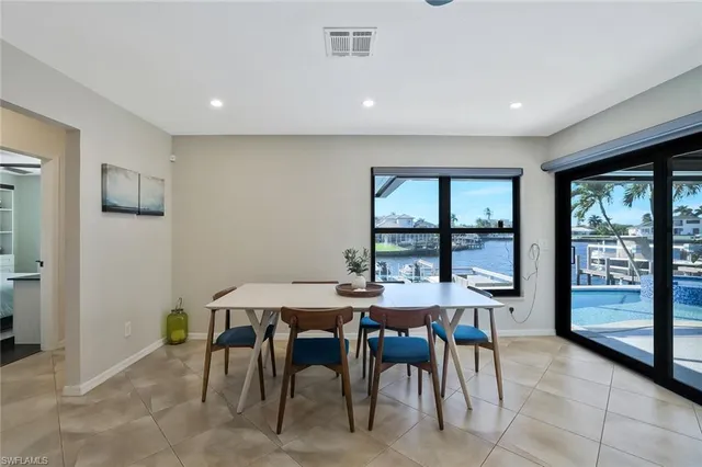 a view of a dining room with furniture and a potted plant