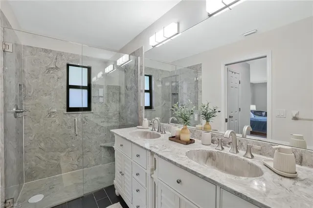 a bathroom with double sink and a mirror