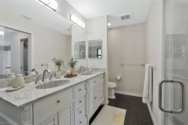 a bathroom with a double vanity sink and a mirror