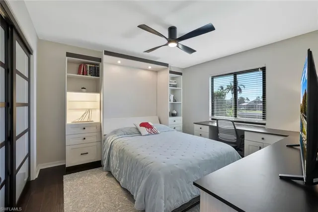 a bedroom with two beds and a large window