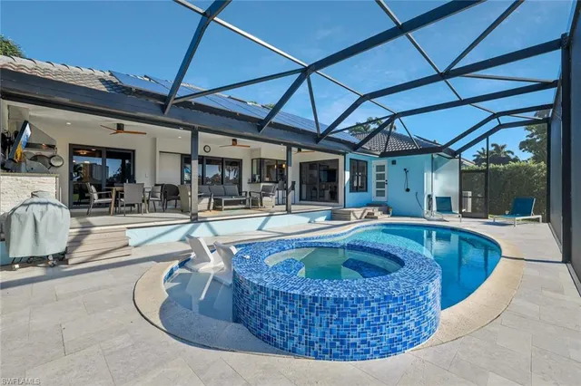 a view of swimming pool with outdoor seating