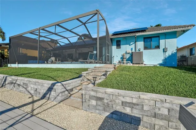 a view of a house with backyard and porch