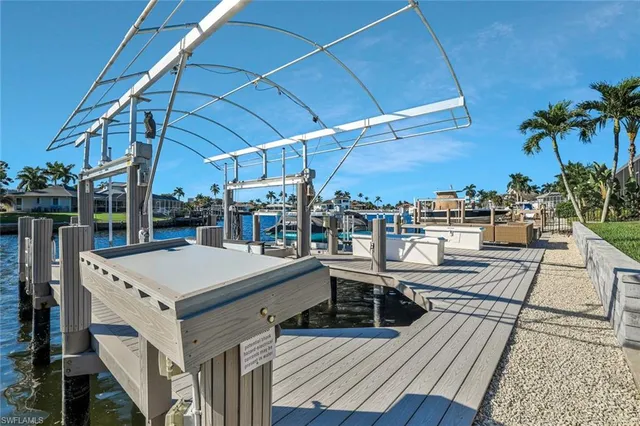 a view of a patio with table and chairs under an umbrella