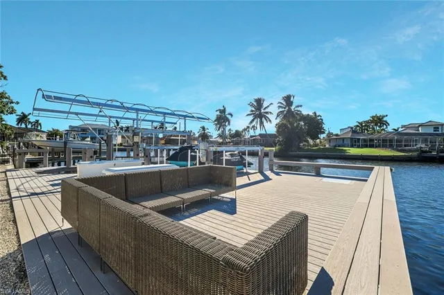 a view of a roof deck with couches and sky view
