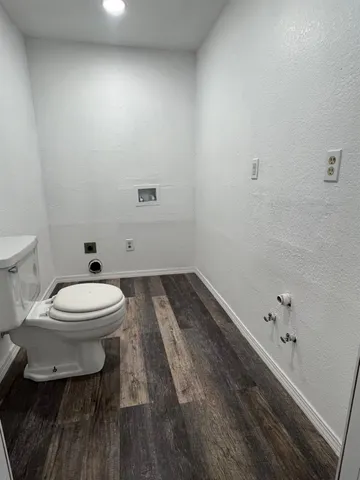 an empty room with a ceiling fan and carpet