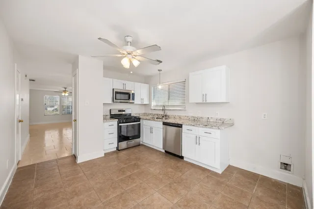 a kitchen with a refrigerator a sink and dishwasher