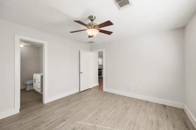 a view of an empty room and wooden floor