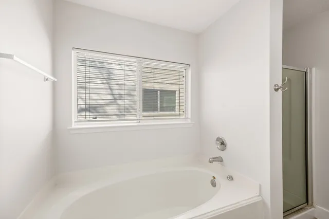 a white bath tub sitting next to a window