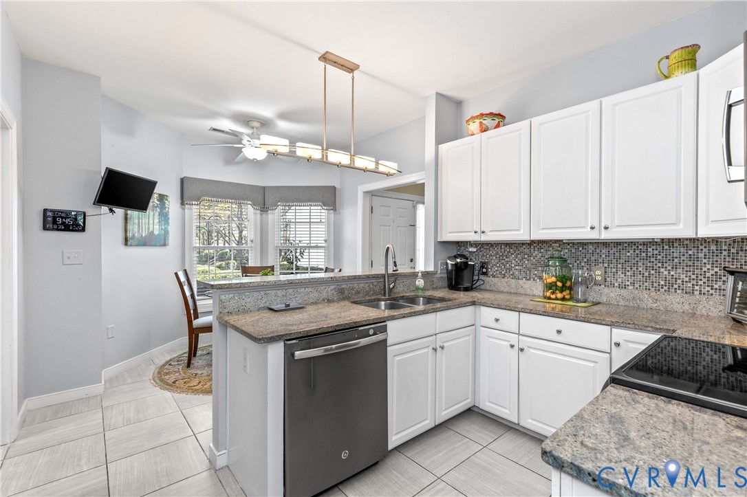 2205 Magnolia Grove Way Midlothian, VA 23113 - Photo 12 of 37 a kitchen with a sink and cabinets