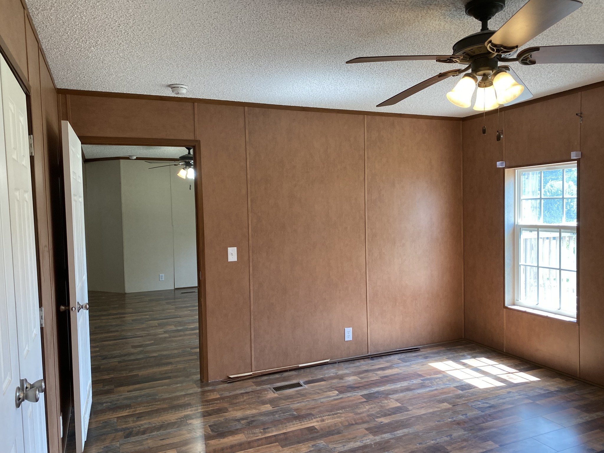 5202 Doss Road Springfield, TN 37172 - Photo 18 of 33 an empty room with wooden floor fan and windows