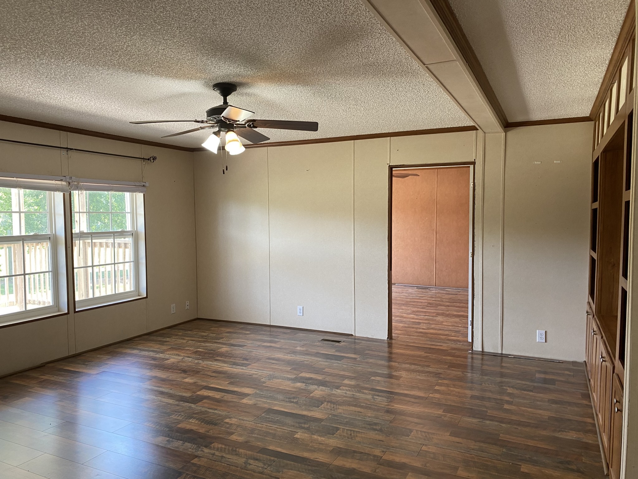 5202 Doss Road Springfield, TN 37172 - Photo 5 of 33 an empty room with wooden floor chandelier fan and windows