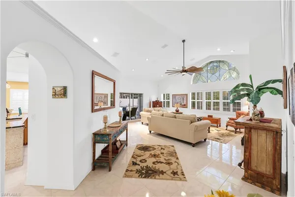 a living room with furniture chandelier and a rug