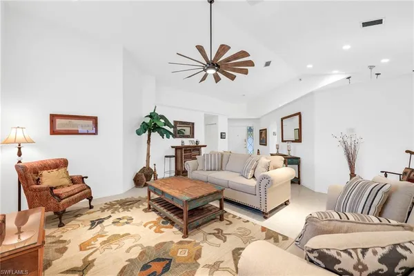 a living room with furniture a rug and a chandelier
