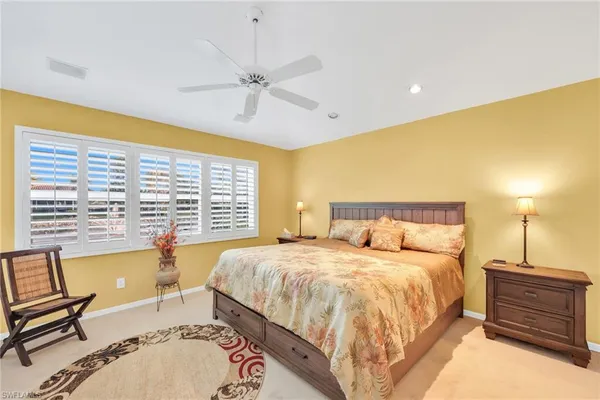 a spacious bedroom with a bed and a chandelier