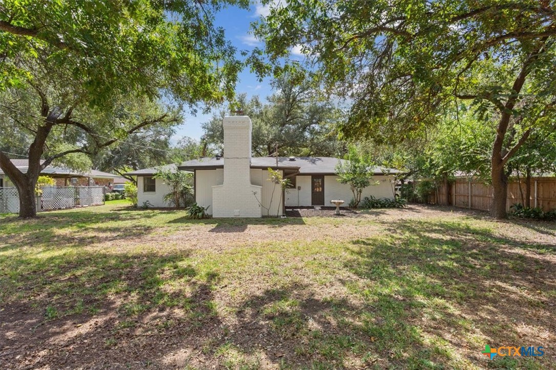 4412 Briar Cliff Road Temple, TX 76502 - Photo 26 of 28 a backyard of a house with a tree