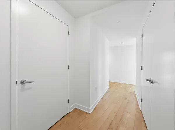 a view of a room with wooden floor