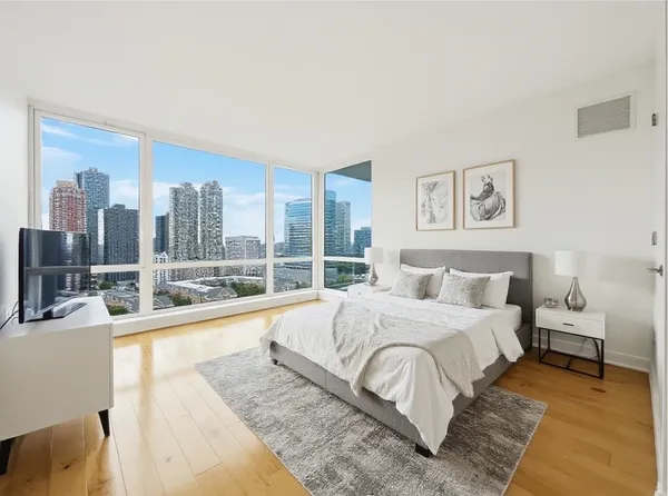 a large bedroom with a large bed and a large window