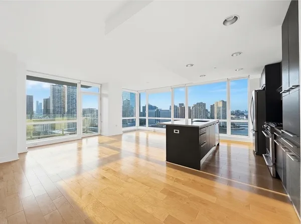 a view of a living room kitchen and a large window