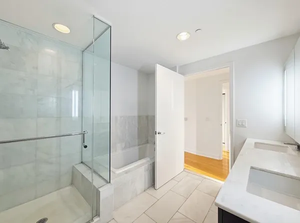 a bathroom with a tub and shower