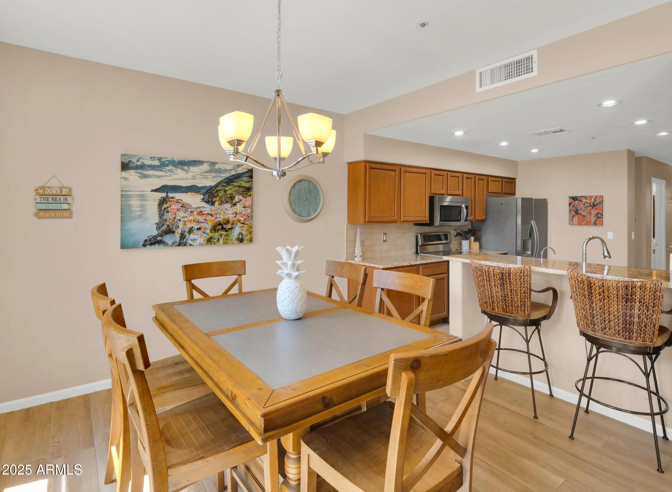 7700 East Gainey Ranch Road, Unit 120 Scottsdale, AZ 85258 - Photo 11 of 57 a view of a dining room with furniture and wooden floor