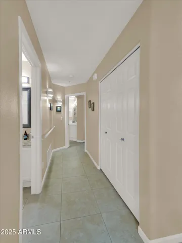 a bedroom with a bed and painting on the wall