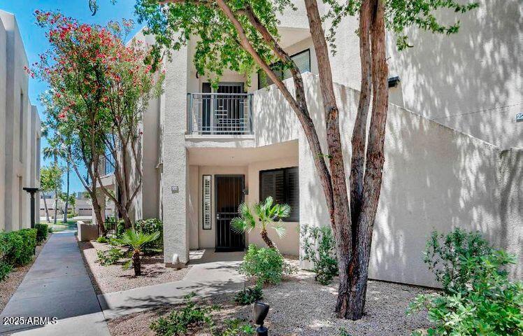 7700 East Gainey Ranch Road, Unit 120 Scottsdale, AZ 85258 - Photo 2 of 57 a front view of a house with garden