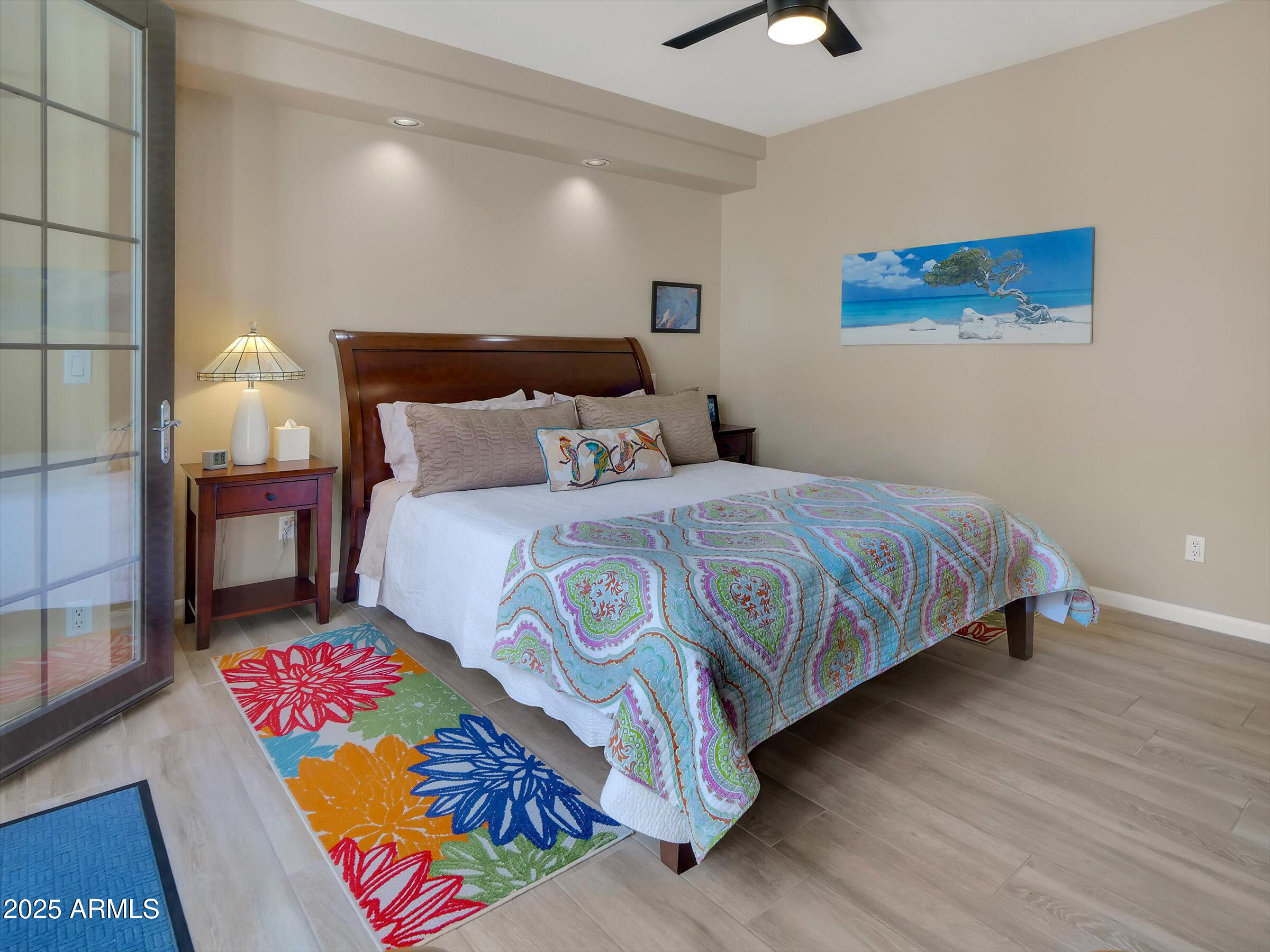 7700 East Gainey Ranch Road, Unit 120 Scottsdale, AZ 85258 - Photo 22 of 57 a bedroom with a bed and a lamp