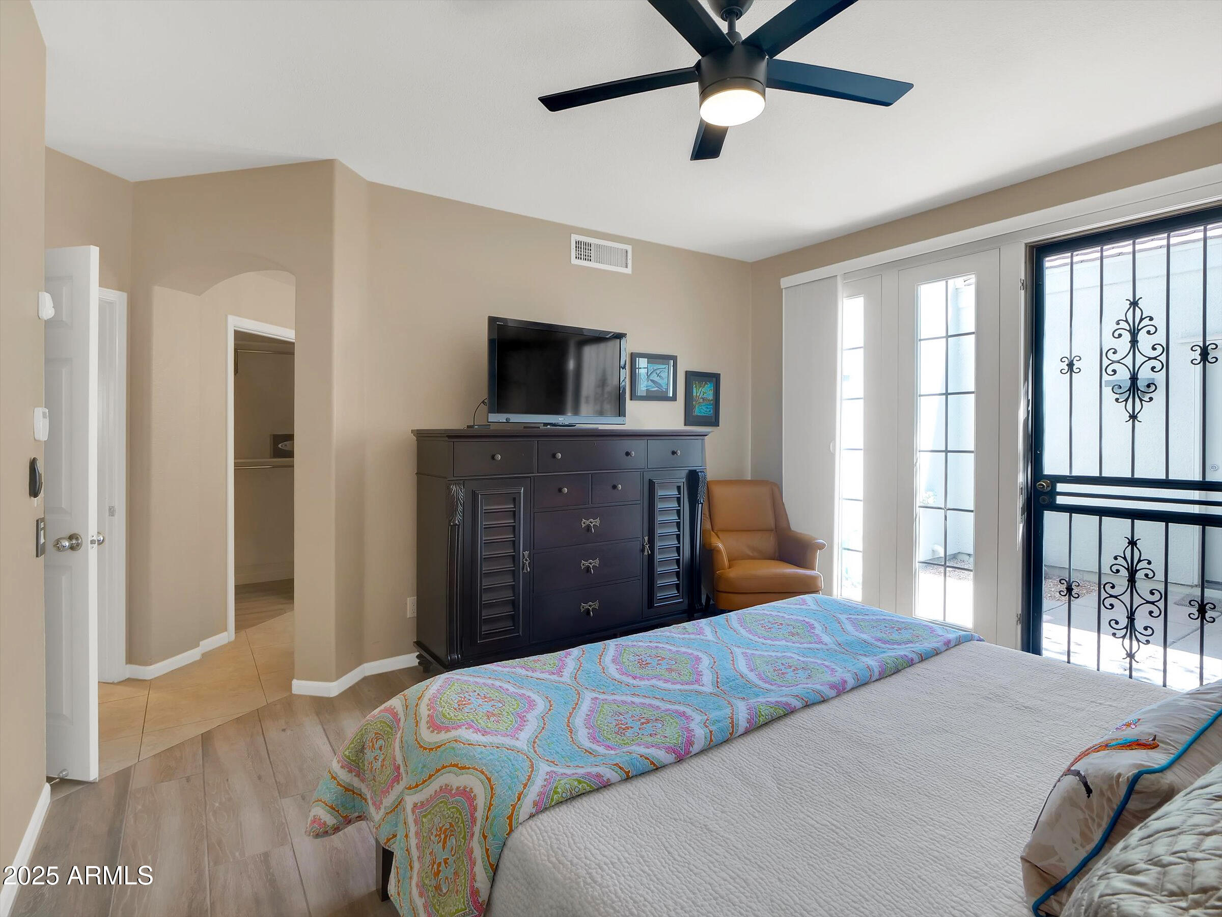 7700 East Gainey Ranch Road, Unit 120 Scottsdale, AZ 85258 - Photo 24 of 57 a bedroom with a bed and a flat screen tv