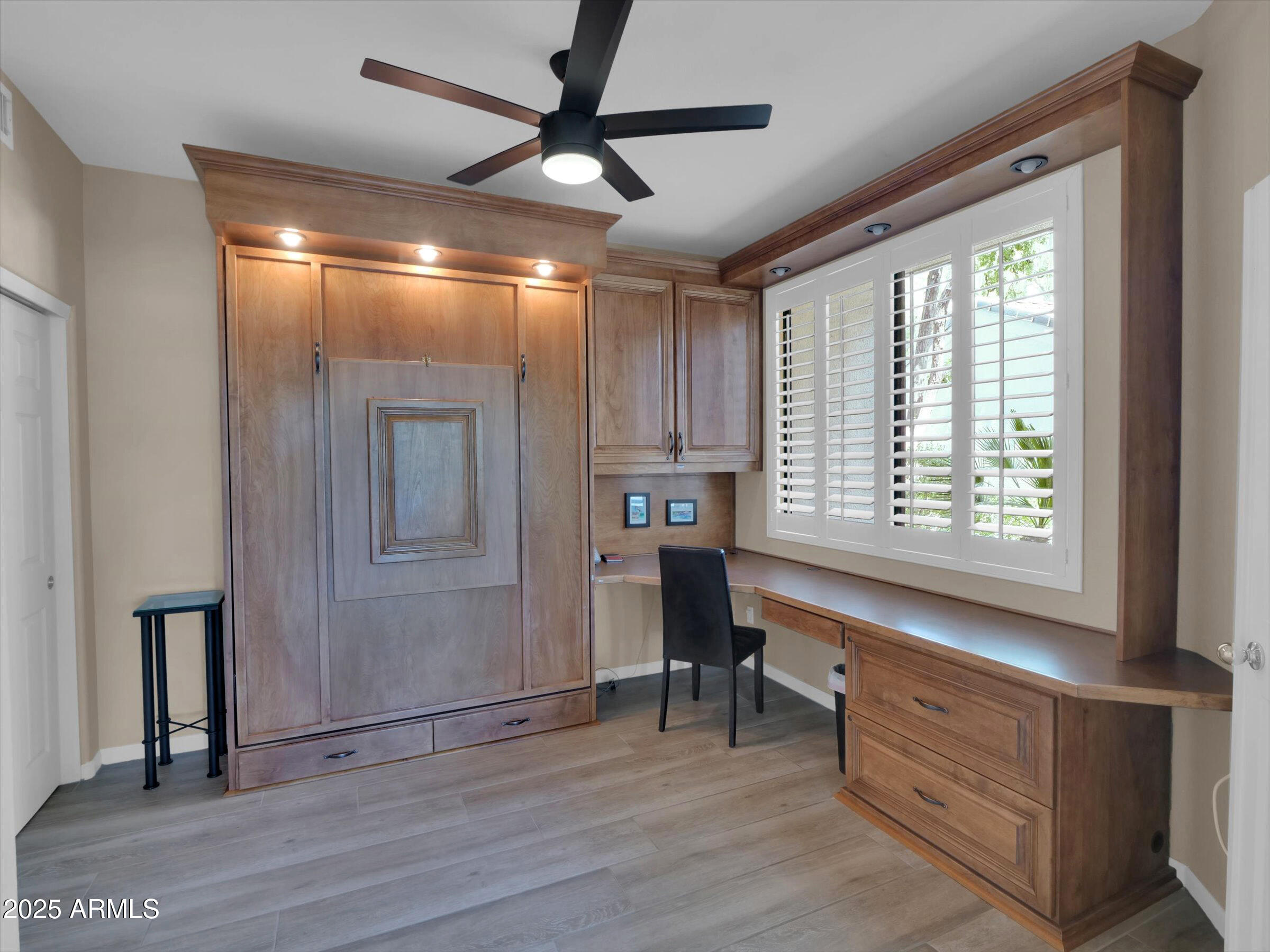 7700 East Gainey Ranch Road, Unit 120 Scottsdale, AZ 85258 - Photo 34 of 57 a view of an empty room with a window and wooden floor