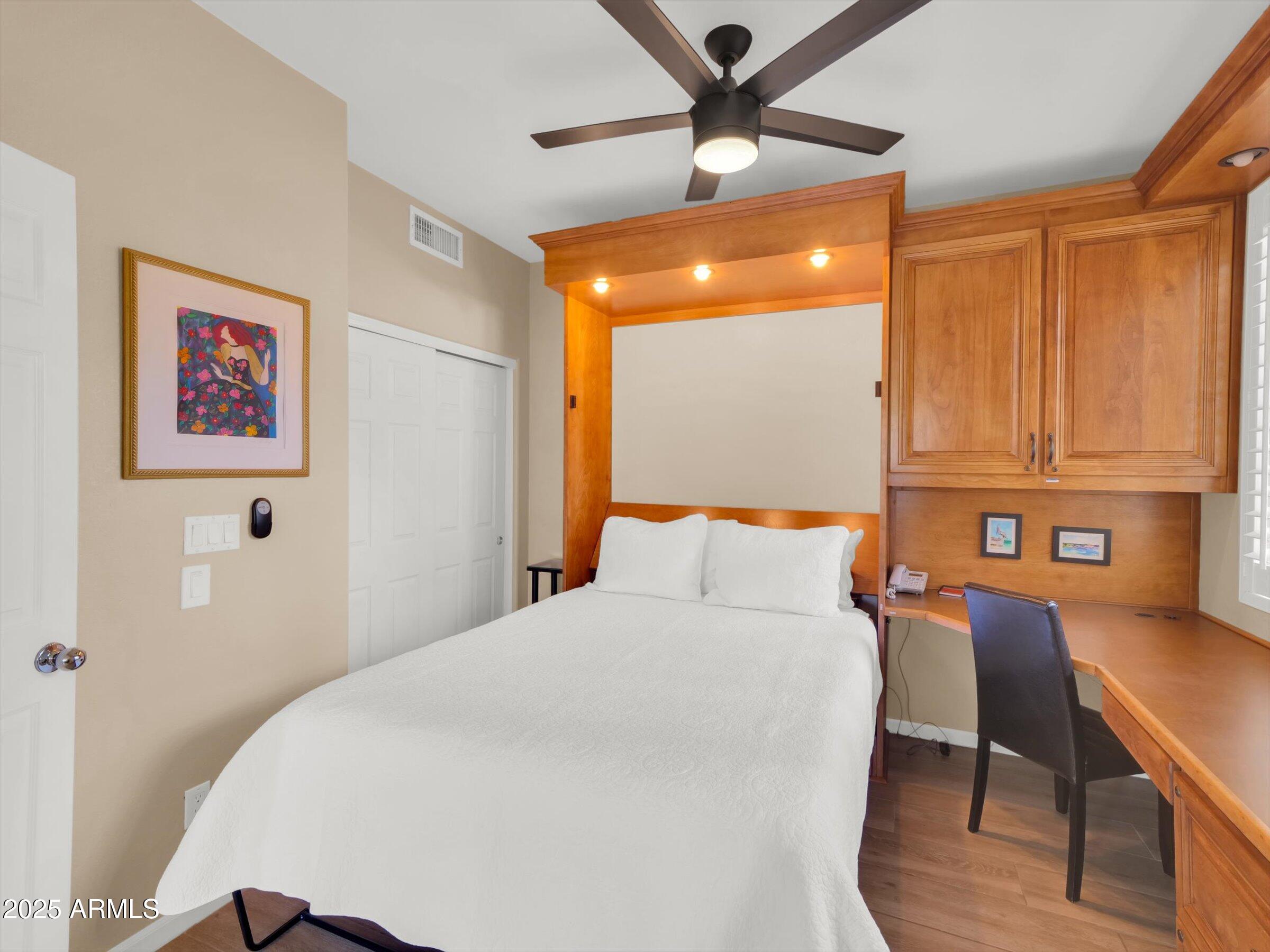 7700 East Gainey Ranch Road, Unit 120 Scottsdale, AZ 85258 - Photo 35 of 57 a bedroom with a bed and a chandelier