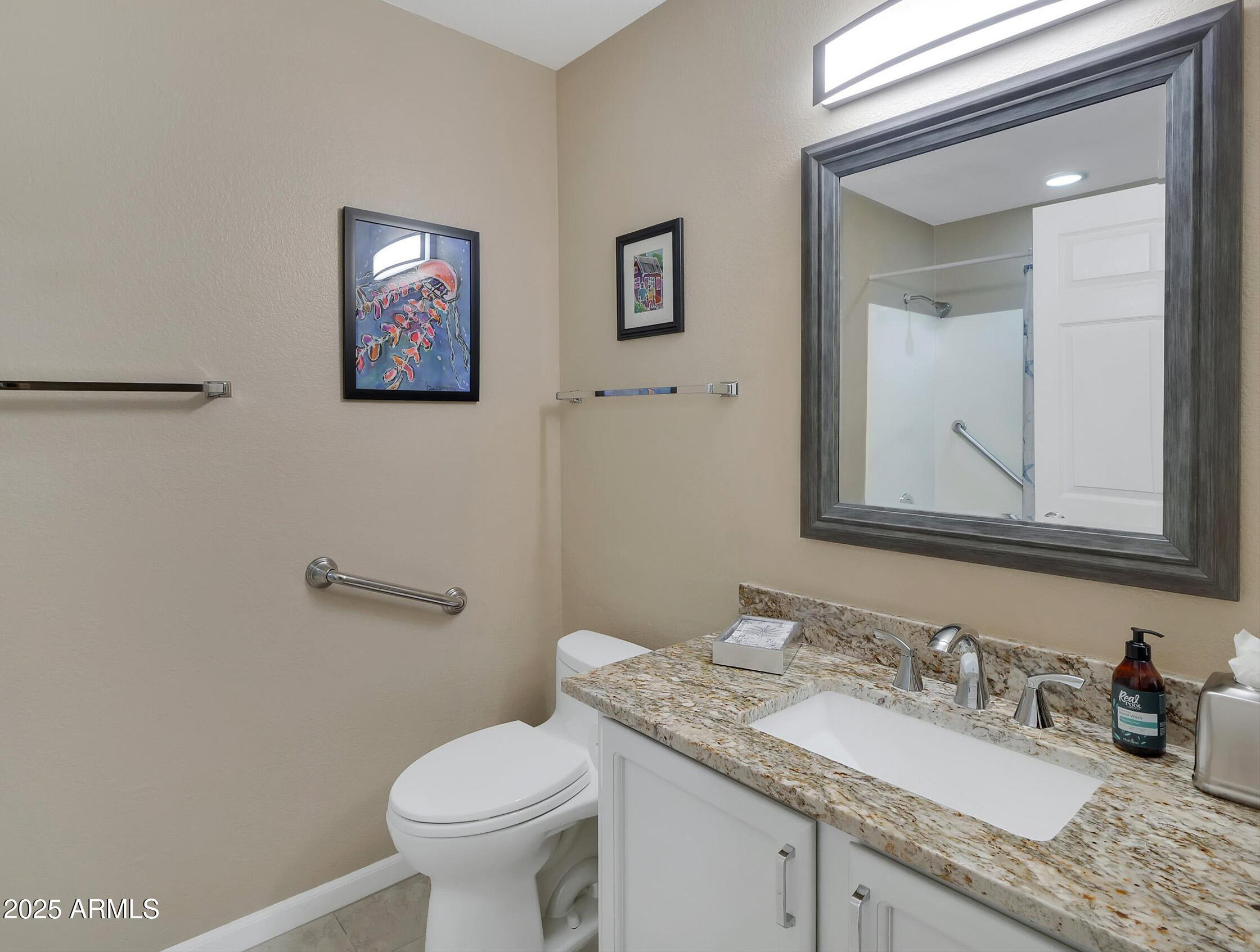7700 East Gainey Ranch Road, Unit 120 Scottsdale, AZ 85258 - Photo 36 of 57 a bathroom with a granite countertop toilet sink and mirror