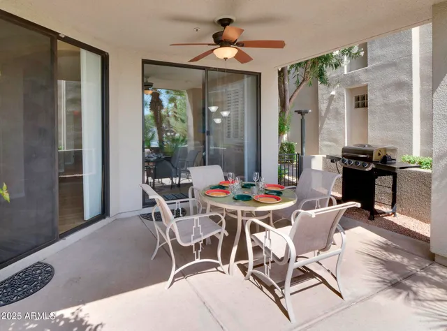 a view of a swimming pool with a bench and trees