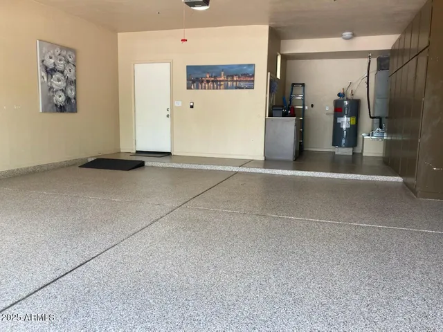 a view of a patio with table and chairs under an umbrella