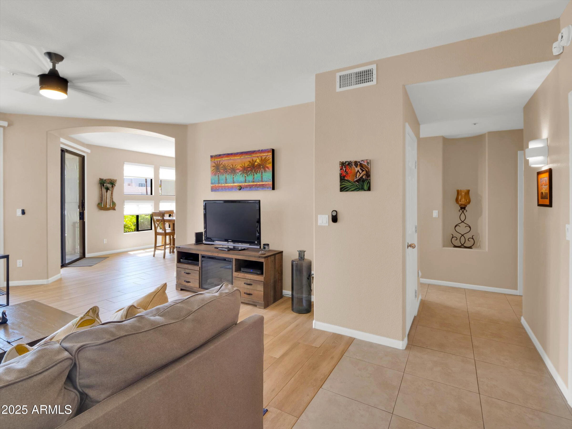 7700 East Gainey Ranch Road, Unit 120 Scottsdale, AZ 85258 - Photo 5 of 57 a living room with furniture and a flat screen tv