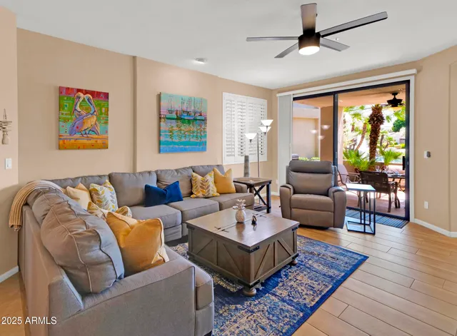 a living room with furniture ceiling fan and a rug