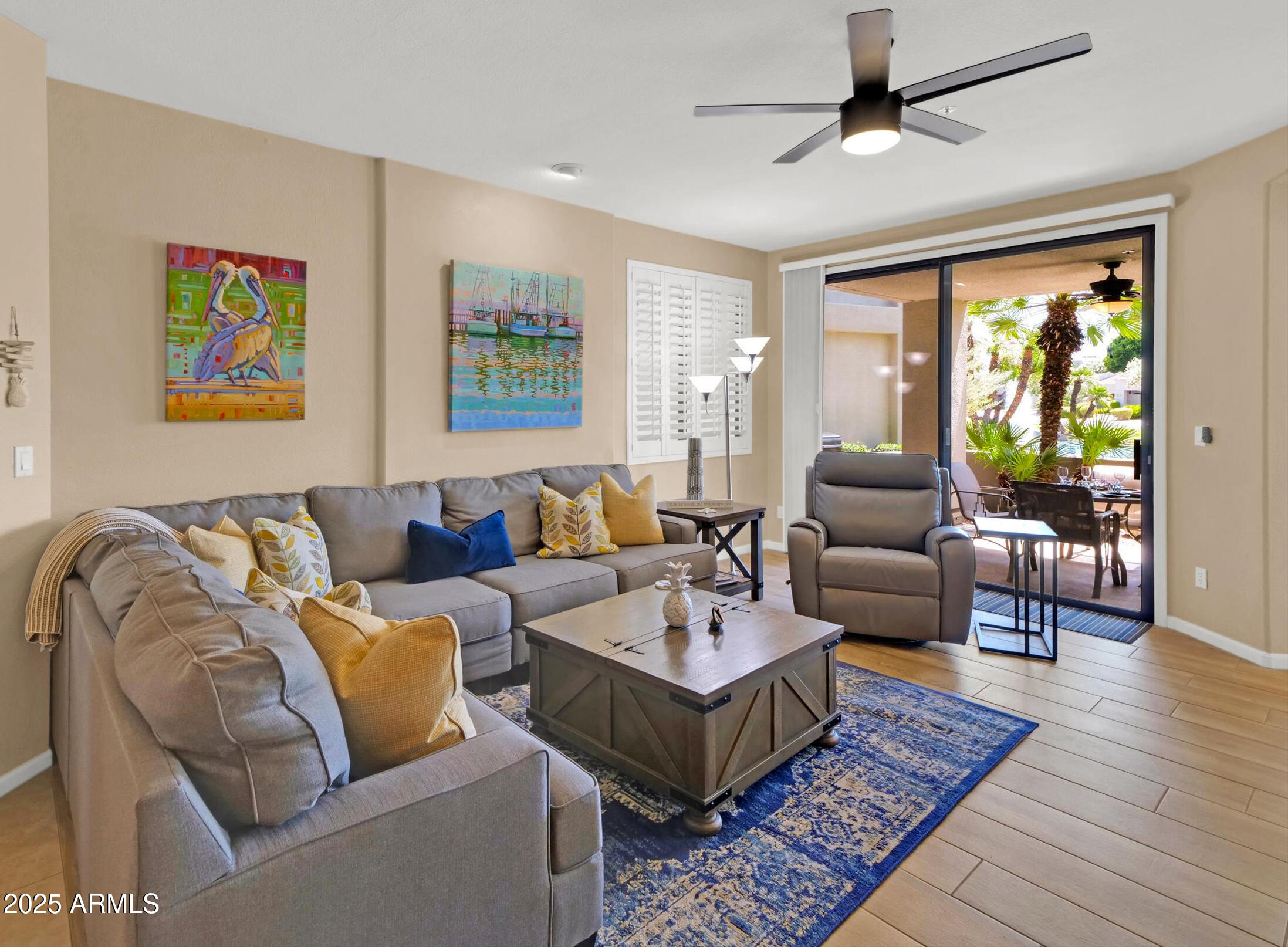 7700 East Gainey Ranch Road, Unit 120 Scottsdale, AZ 85258 - Photo 6 of 57 a living room with furniture ceiling fan and a rug