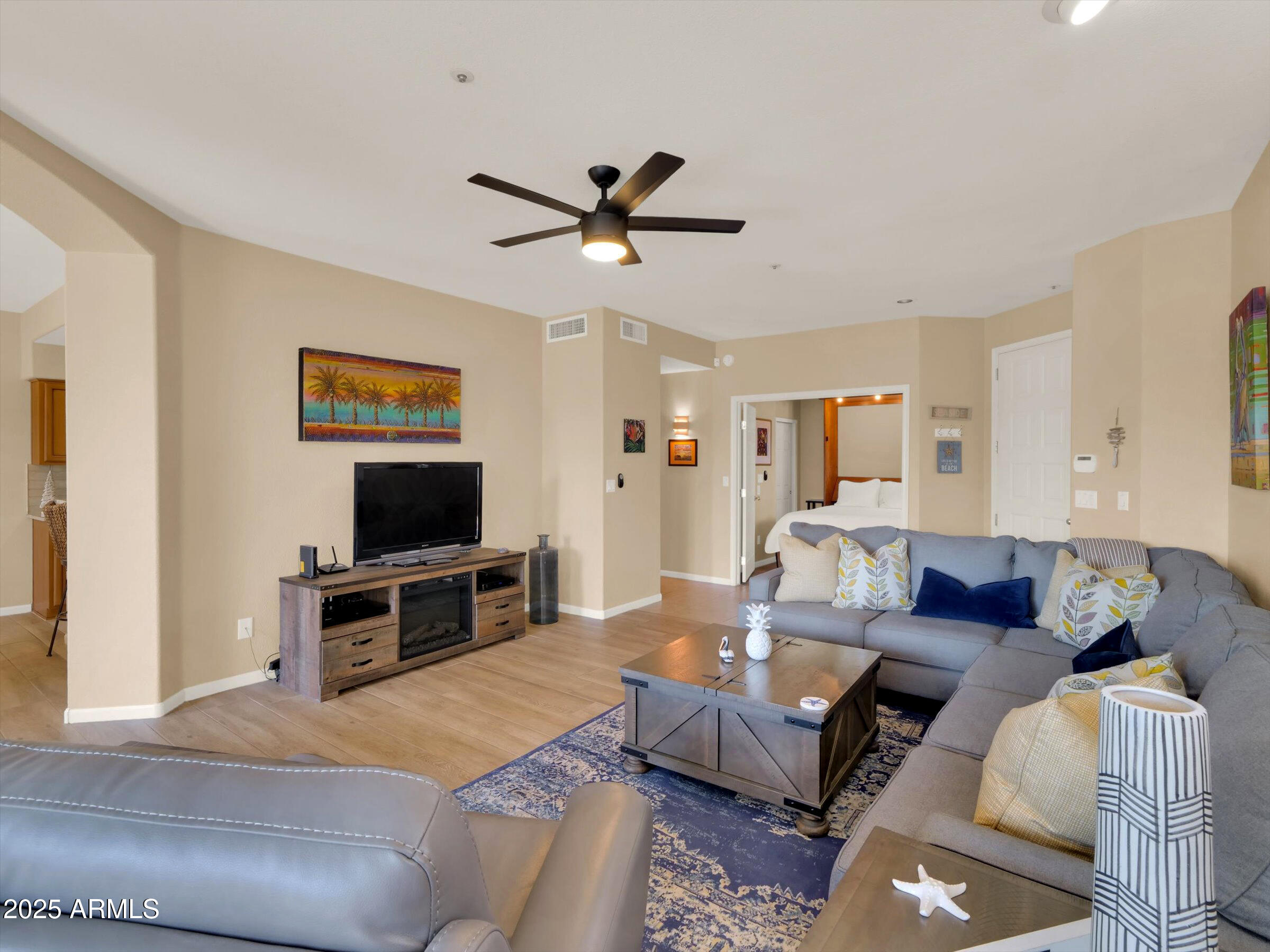 7700 East Gainey Ranch Road, Unit 120 Scottsdale, AZ 85258 - Photo 9 of 57 a living room with furniture and a flat screen tv